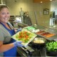 Sauté cook Jennifer Bettencourt shows healthier menu items available at Fairview Lakes.